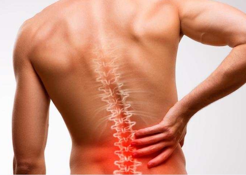 Man grabbing his back that is red, signaling pain.